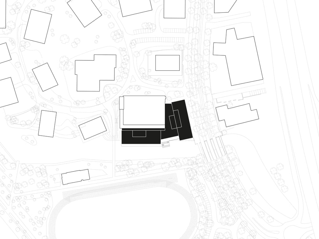 Situatietekening van Xplore in Elzenhagen, Amsterdam Noord, met het schoolgebouw in zwart